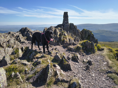 An impressive cairn marks the summit of Place Fell. Far-ranging mountain views