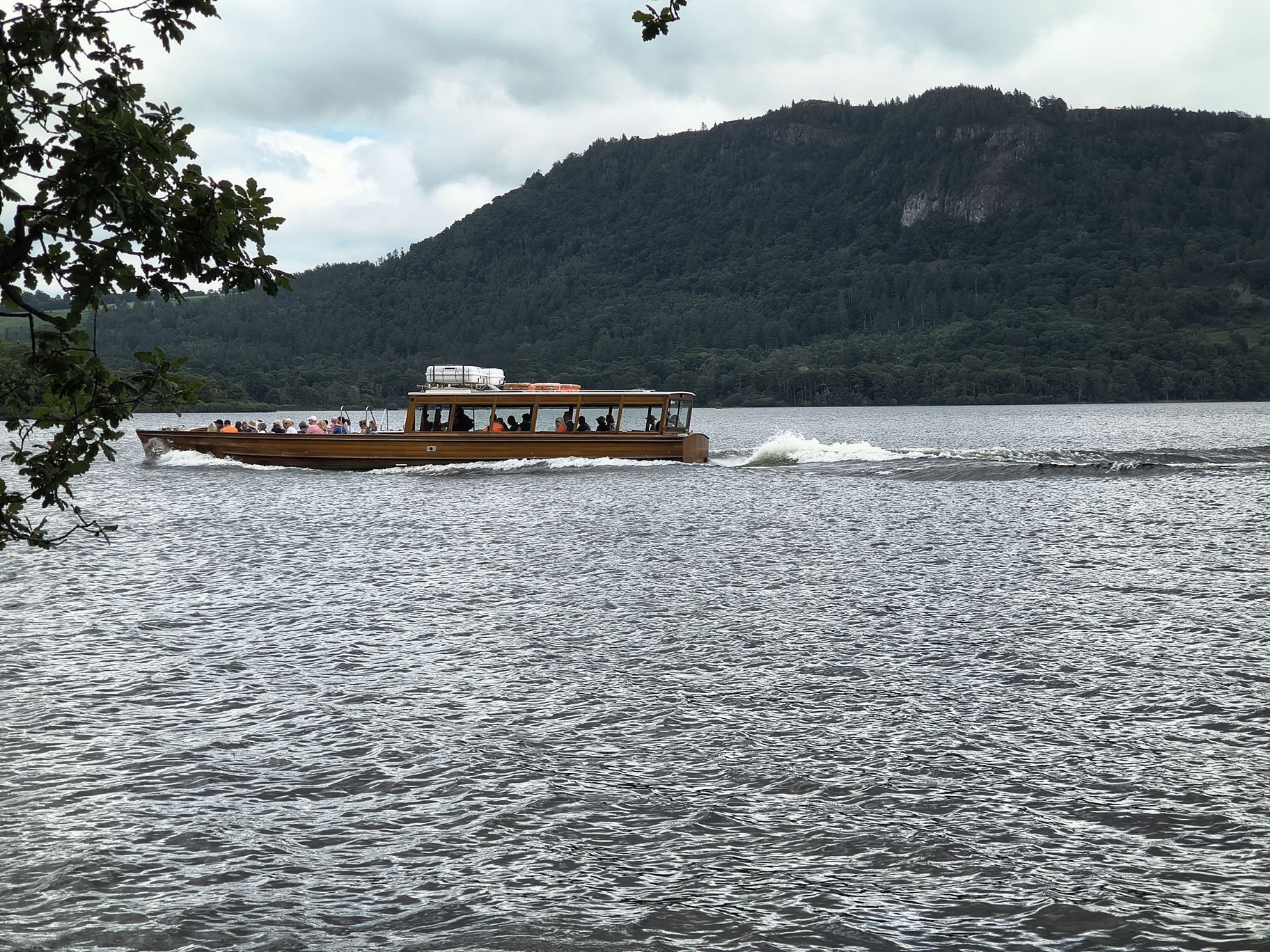 The launch on Derwent Water passes from right to left on its way to Hawes End, Jun 30, 2025